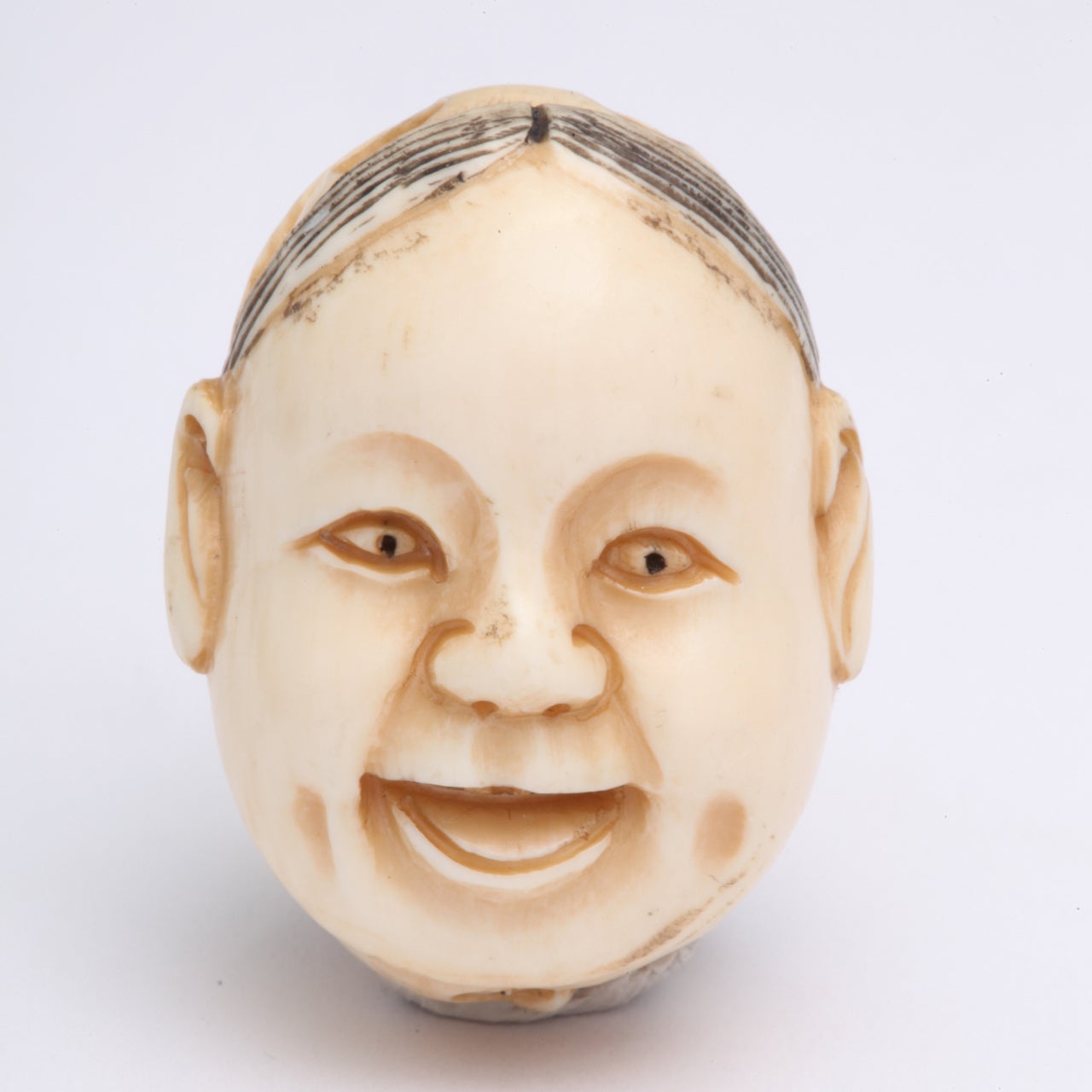 A smiling, dimpled mother, content child and strict, serious father is a winsome antique carved pendant in ivory that I estimate was made in the late 19th century. Ojime, as jewels such as this are called, were part of Japanese art and culture. They