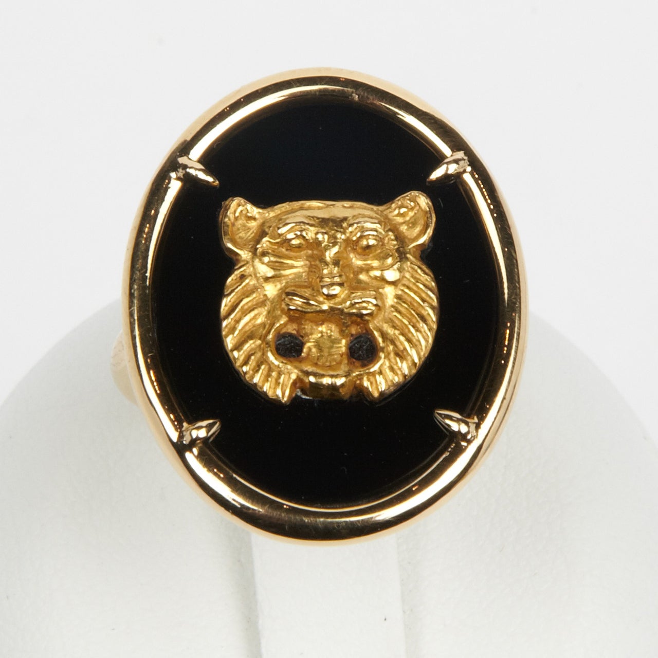 Ring in 18K gold and onyx set with a gold motive representing a lion head, with intricate mane and expressive open mouth and eyes, Achaemenid Art (Persia), 5th century B.C. 
This piece was a bract meant to be sawn on clothes: the original back