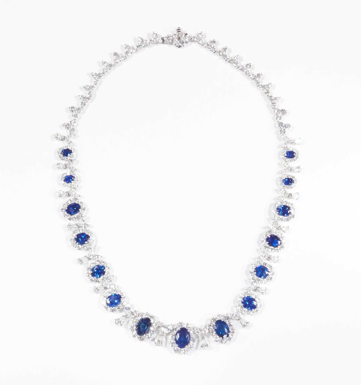 Beautiful blue oval sapphires set in a handmade 18k white gold diamond necklace. 

Over 25 carats of sapphires.

Over 25 carats of white diamonds.

Please contact us for more information.