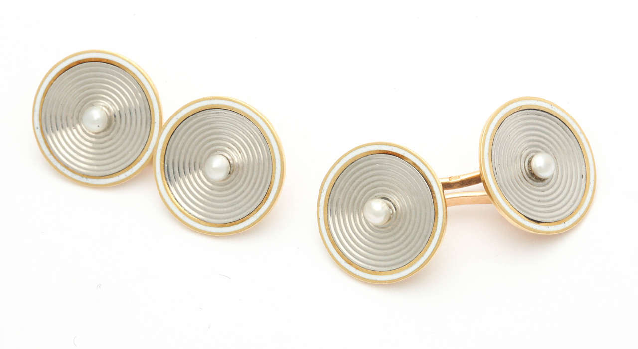 Pair of elegant double sided cufflinks in 18k gold from Paris, each concentric 18k white gold discs with button pearl centres bordered by white enamel, the base in 18k yellow gold, fully hallmarked in several places with eagle head for French 18k
