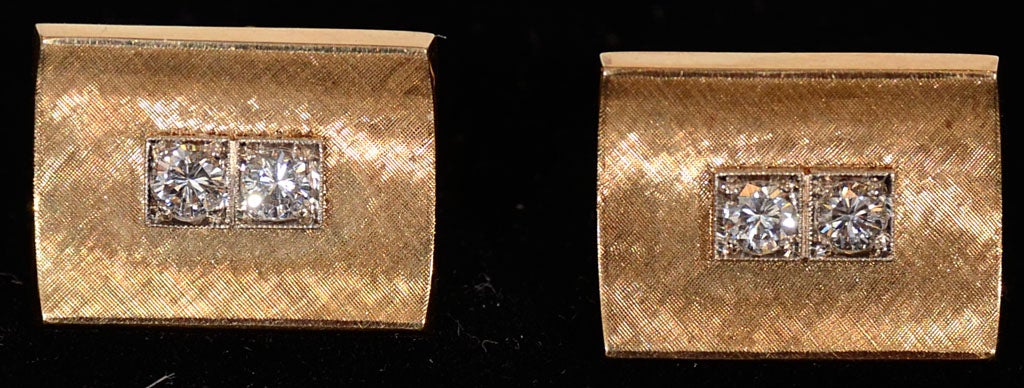 These 14k yellow gold cufflinks each set with two diamonds, total carat weight approximately 1.2 carats and 10.0 Dwts of gold. . The Diamonds are set in white gold with a florentined yellow gold mounting.