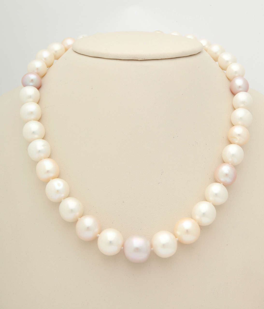 This necklace has superb pastel fresh water pearls with an excellent luster. They are slightly graduated, 16mm to 12 mm. Total length is 18 in. The clasp is 18kt yellow gold with .89cts. white diamonds. This is a great summer necklace!