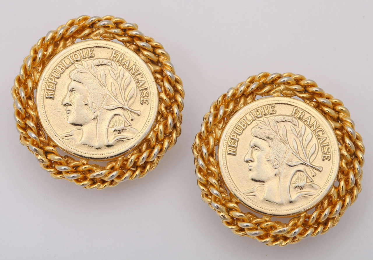 Large gold tone French coin earrings edged in chain links.