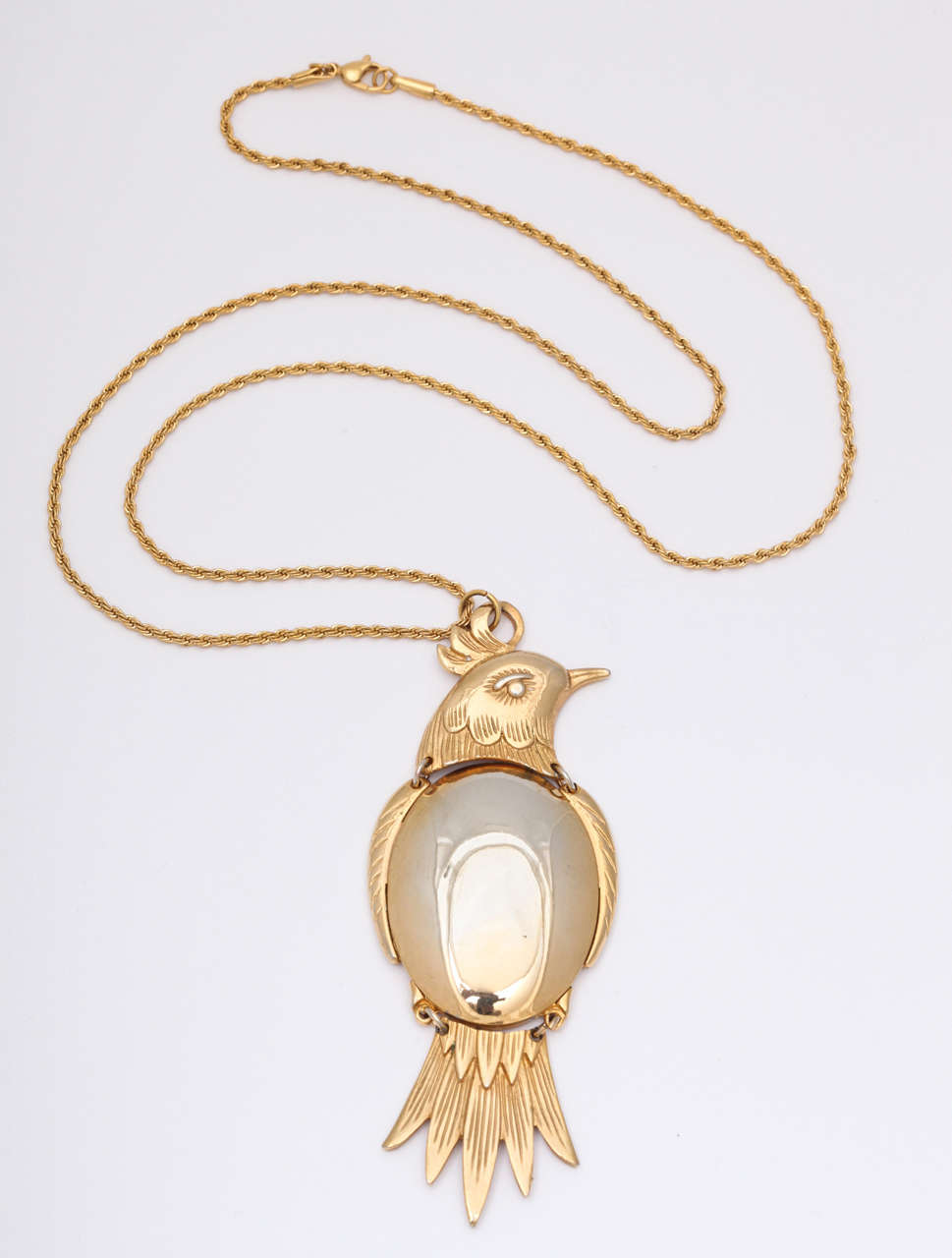 Bird pendant is in three pieces with a silver tone belly. Chain has 14.5