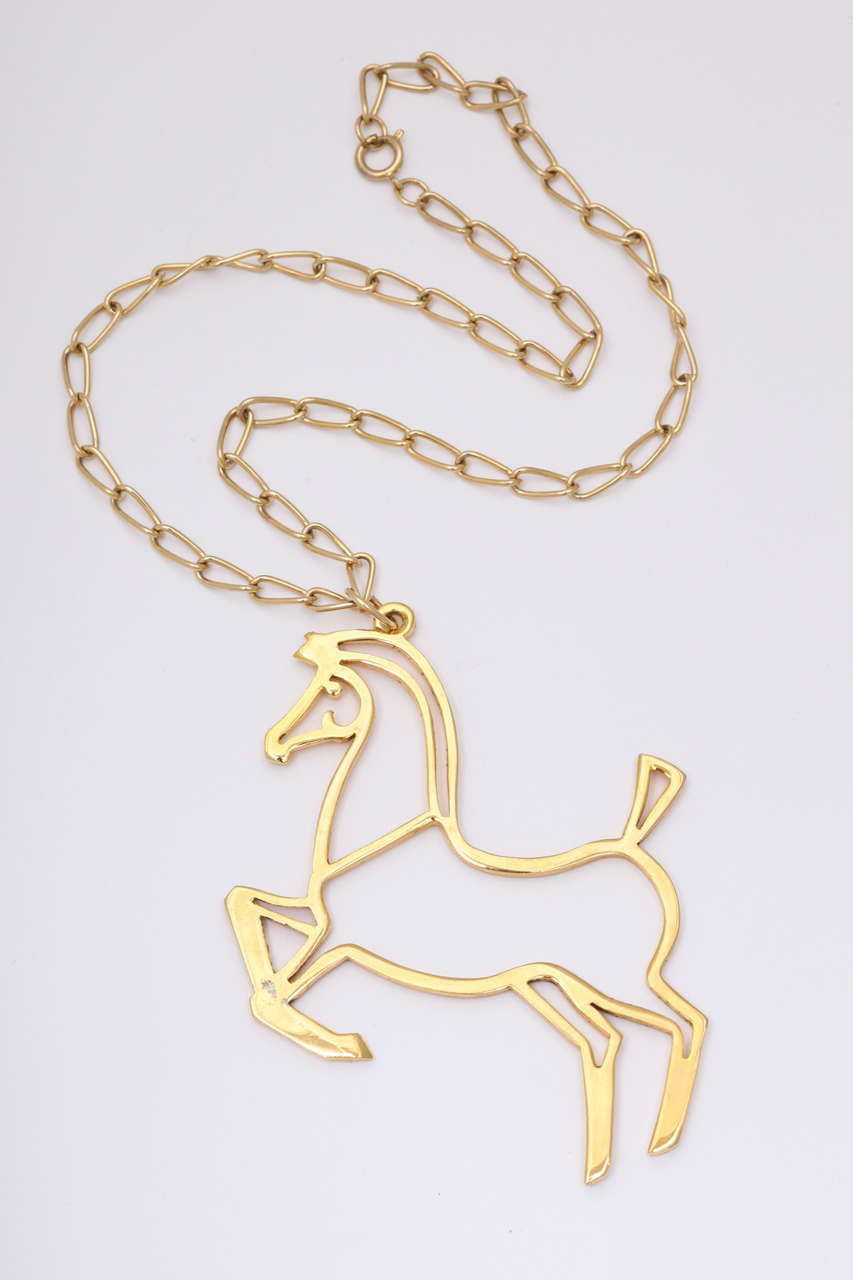 Goldtone modern style horse pendant on chain necklace. Horse is 3.25