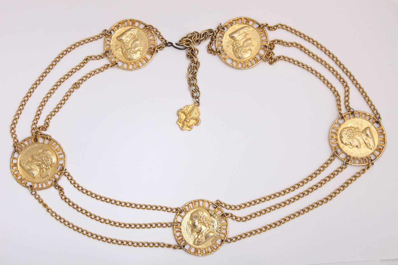 Goldtone chain & coin belt. Each coin depicts a profile of Shakespeare with the words: Hamlet, Macbeth, Romeo, and Juliet along the edge. Auxilliary chain is 6.5