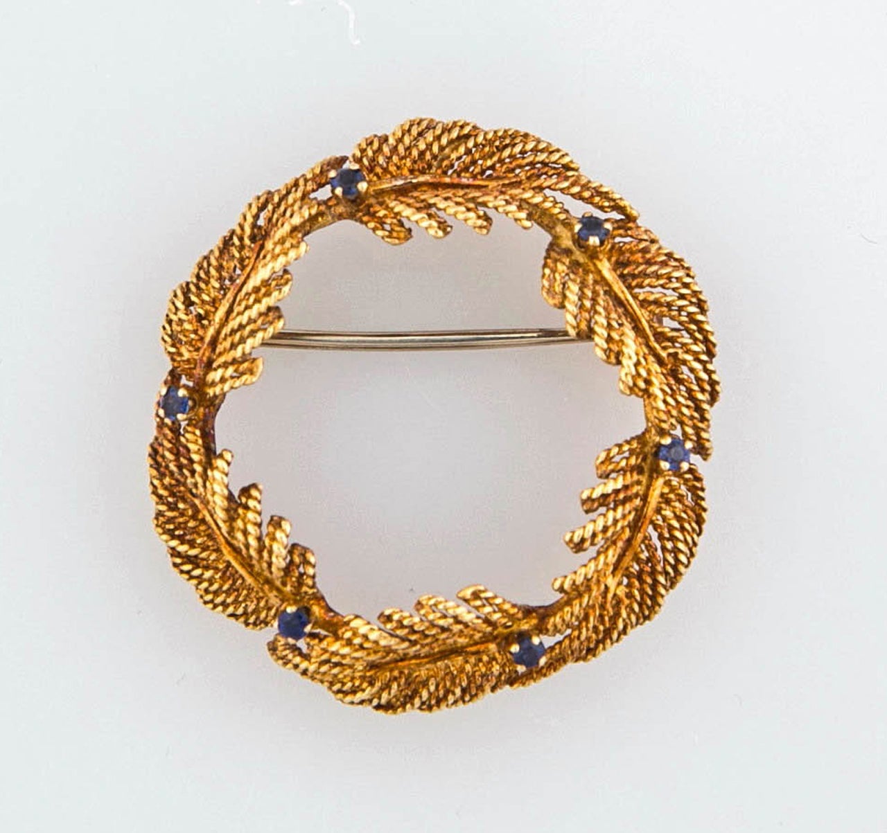 18K round leaf style brooches with sapphires