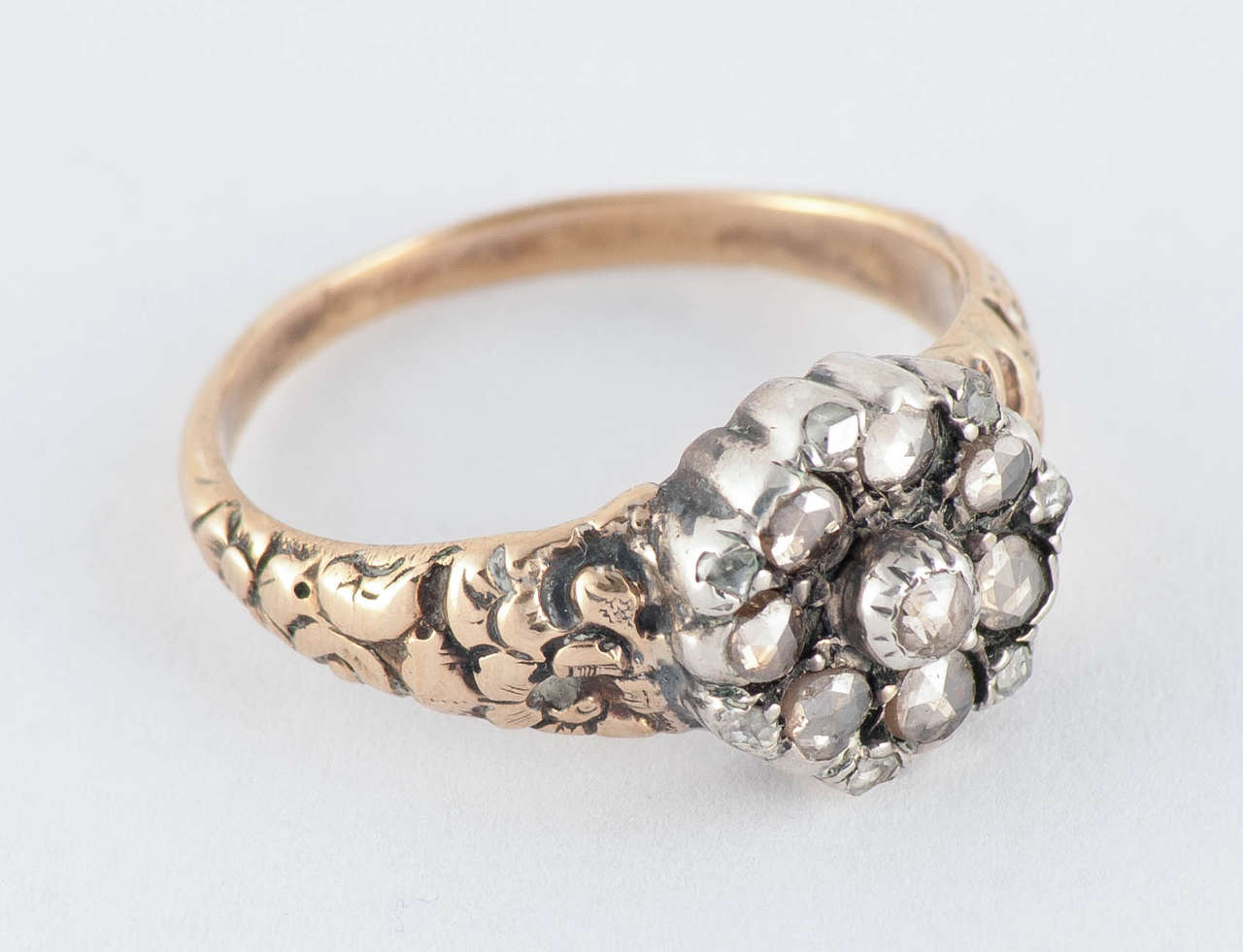 Georgian Dutch crown diamond cluster ring set in 15K chased gold. Dutch crown is the name of a cut of rose diamonds having the most facets. ring has a repousse band, the diamonds are set in silver. It is a size 7 1/2.   