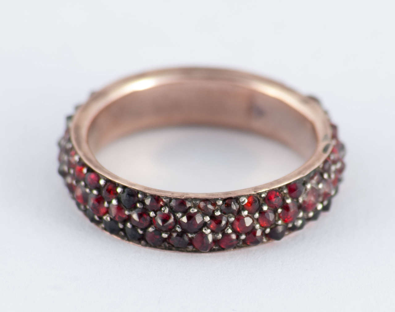Bold late Victorian Bohemian garnet eternity band set in 9K gold. Wonderful to wear alone or stacked with other rings. The ring is a size 6 1/2 and measures 1/4