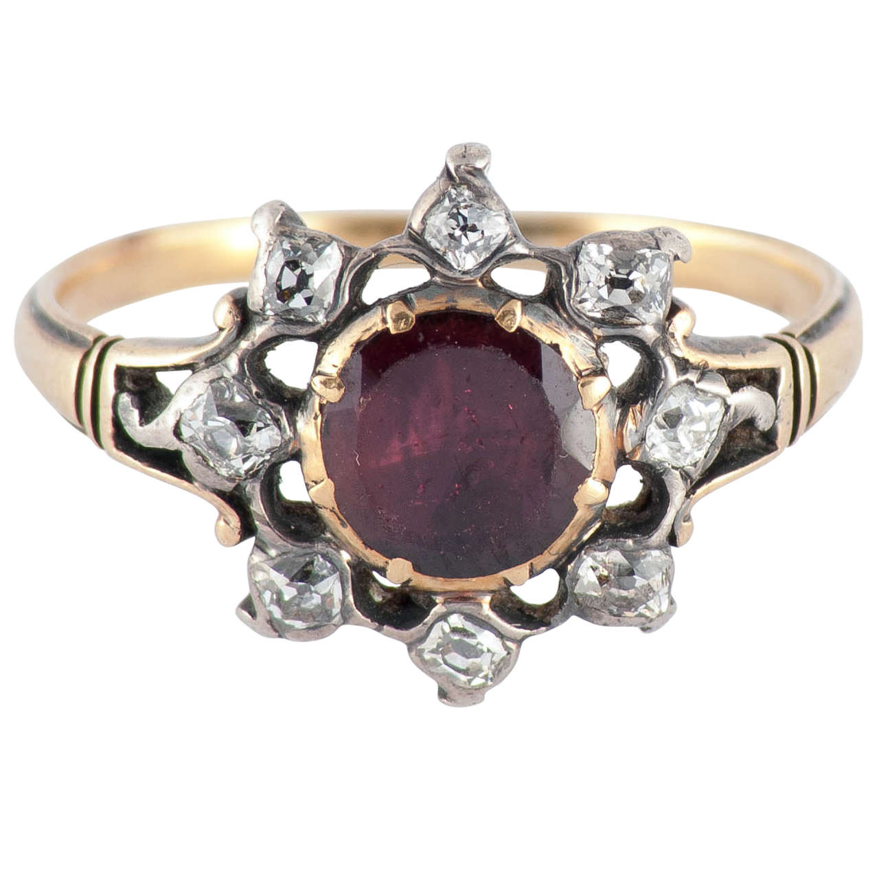 Sparkling Georgian almondine garnet cluster ring surrounded by eight cushion cut diamonds in a starburst design set in 15K yellow gold and silver. Lovely to wear day or night. The ring is a size 6 1/2 and measures 9/16