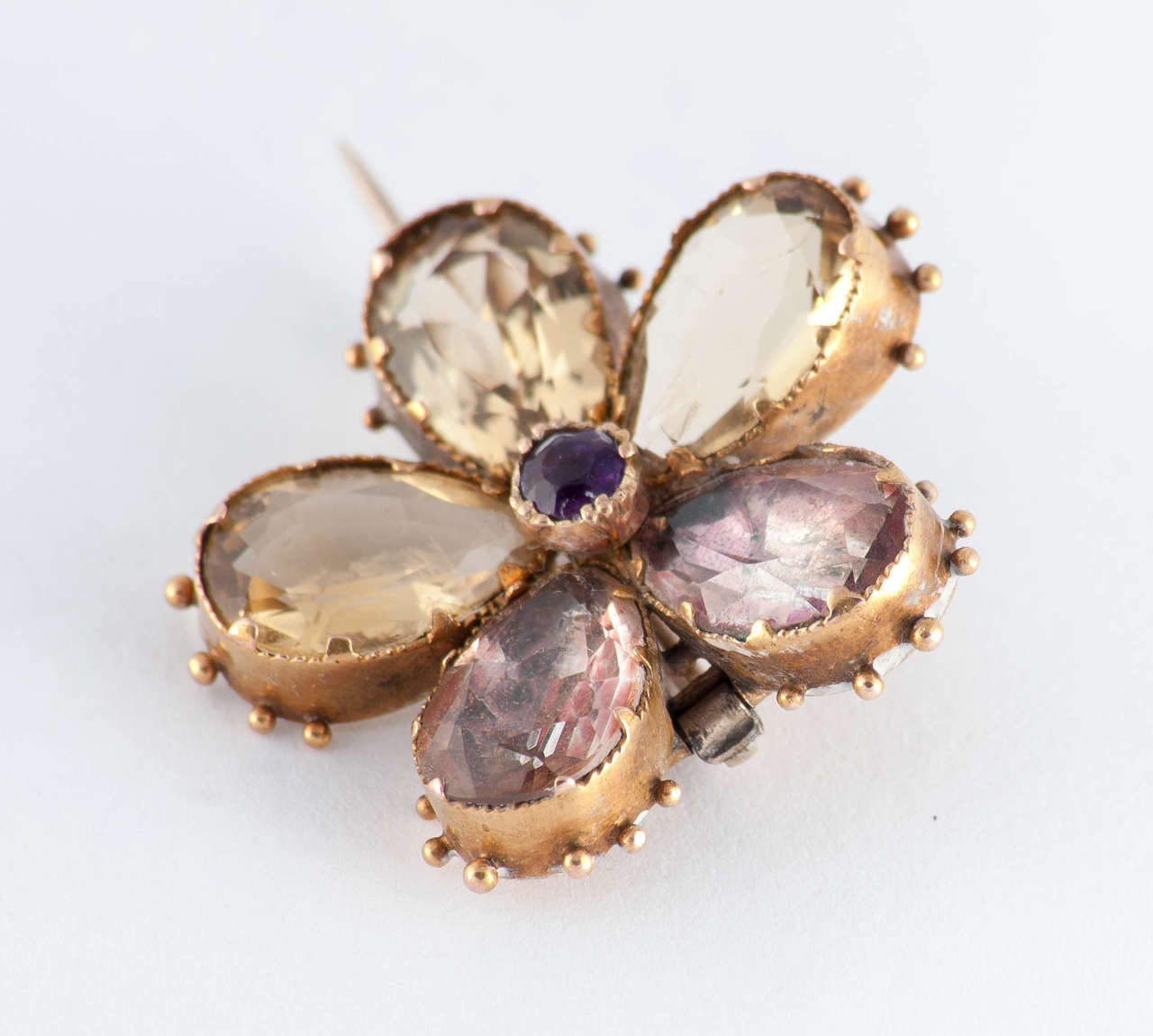 Dainty Georgian pansy pin set with amethysts and citrines in 18K gold. Pansy pins were often given as a gift from a loved as the sound of the word pansy was similar to the French 