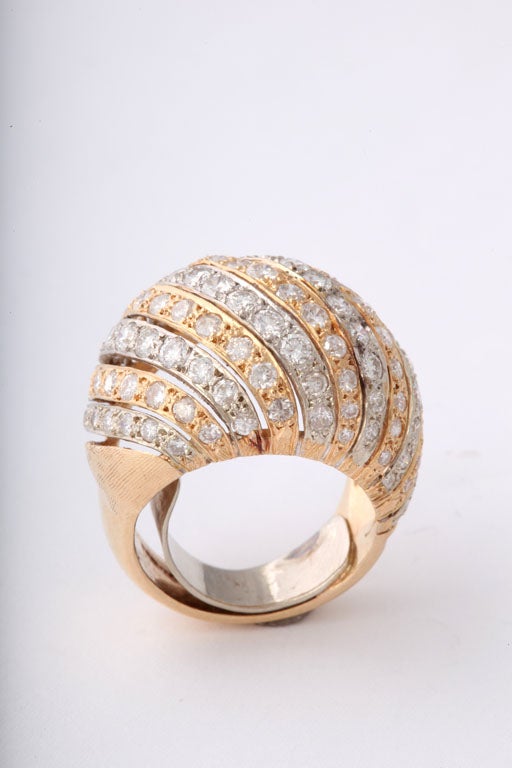 Diamond Dome ring with interchanging white and yellow gold rows of diamonds.  Mounting is 14k gold. 

Size 6.5 US