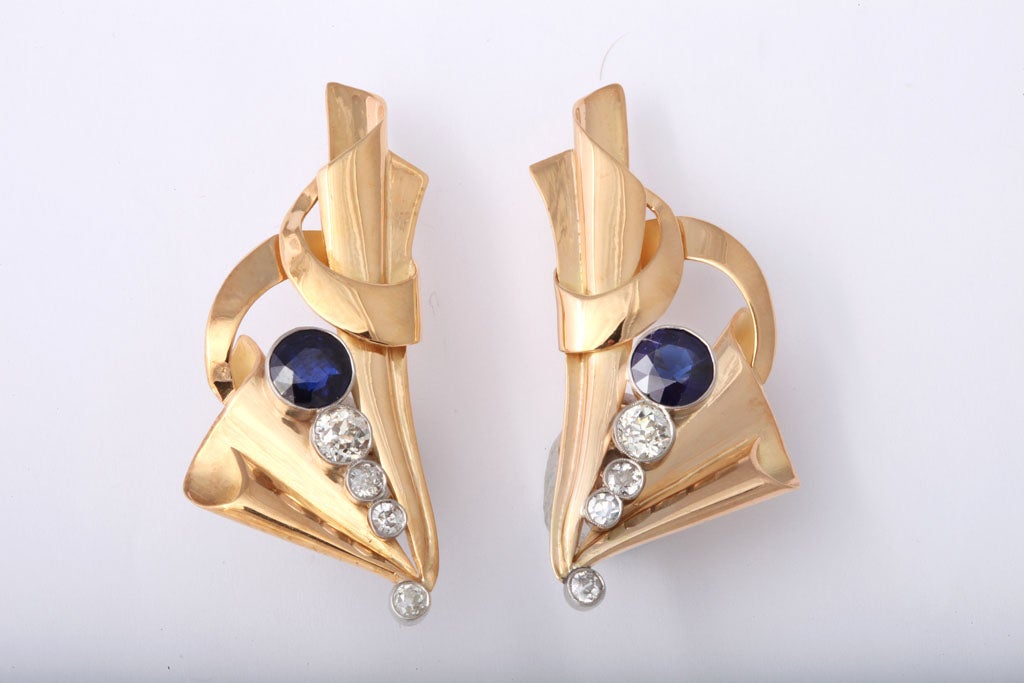 These very impressive clip earrings  go up along the ear.  Each earring has a .75c sapphire as well as 3 smaller diamonds. The total weight in diamonds is approximately 1.60 carats.  The mounting is 18k yellow gold.