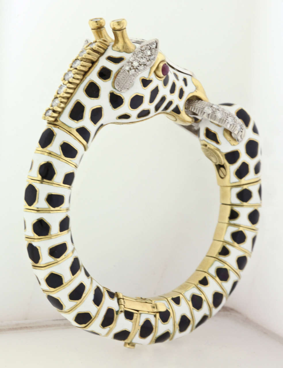 Magnificent enamel, gold and diamond Giraffe hinged bracelet from Frascarolo Italy, circa 1971, is in mint condition, the ultimate expression of the 70's era, with its bold black and white enamel, ruby eyes, diamond studded heads and clasp, and