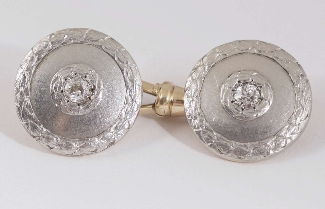 Pair of Edwardian yellow gold and platinum cufflinks with floral border. Austria, circa 1910.