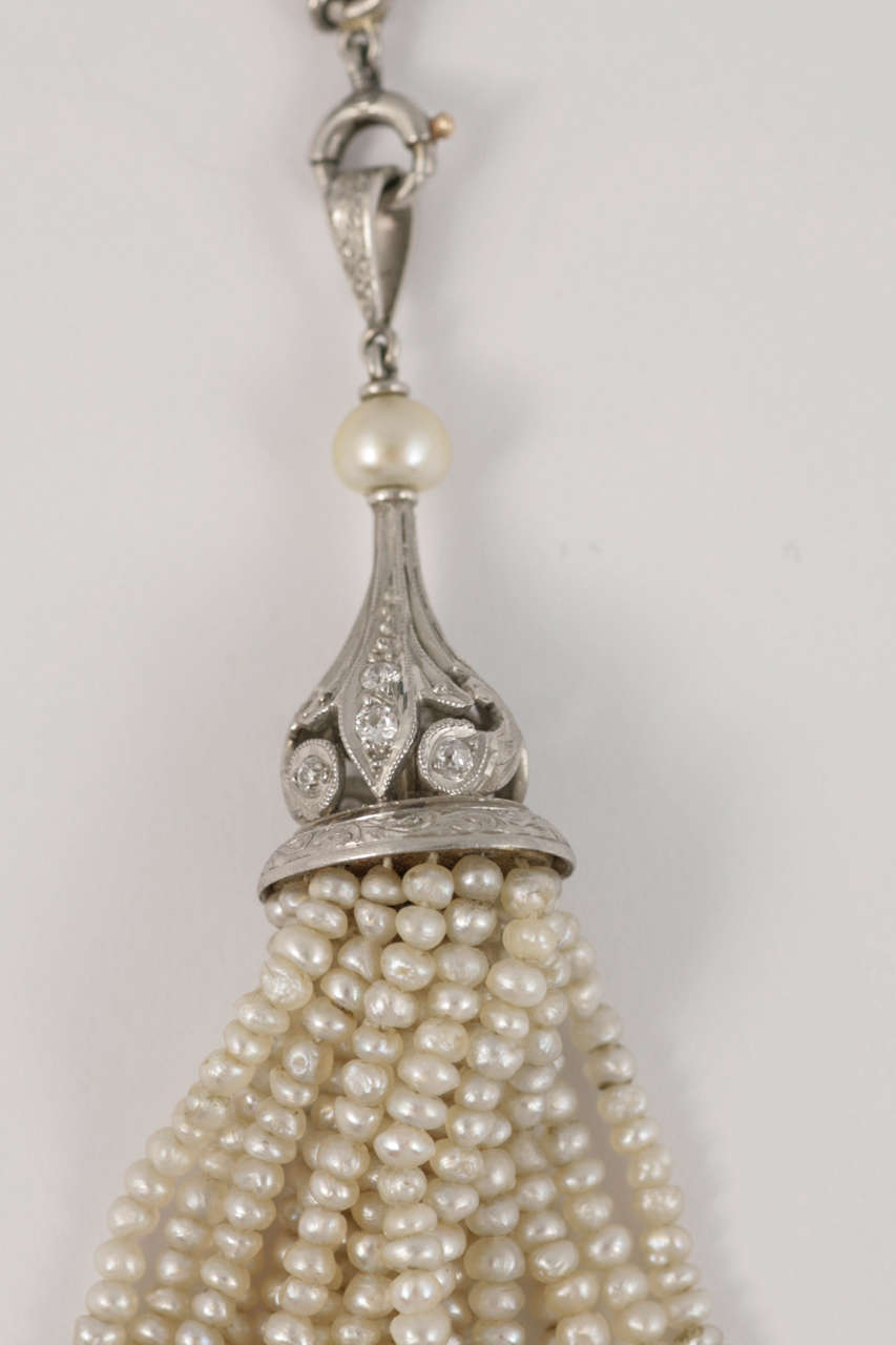 Natural Pearl tassel suspended from Platinum set Diamond crown on chain.
