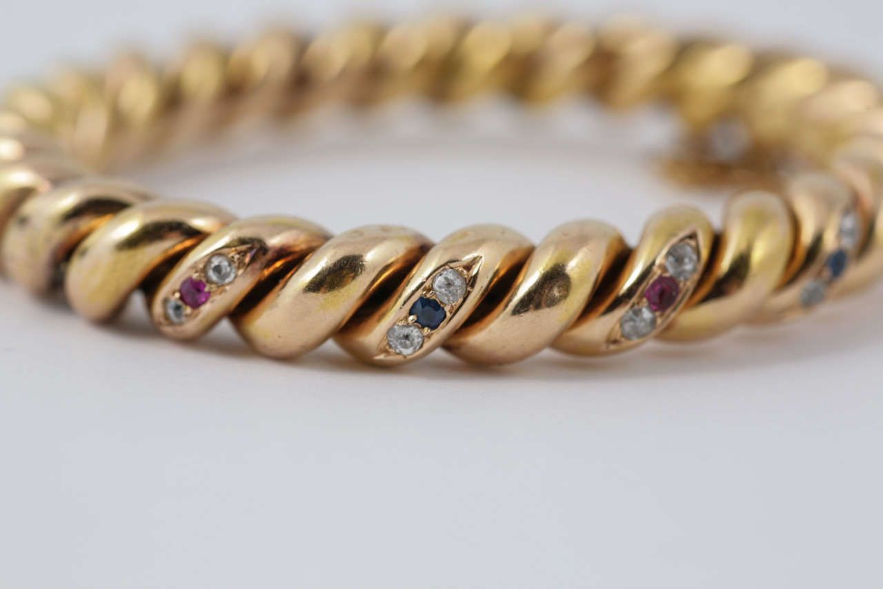 Late Victorian French Twisted Yellow Gold Ruby Sapphire Diamond Bangle Bracelet In Excellent Condition For Sale In London, GB