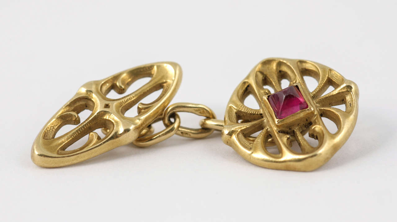 Pair of Art Nouveau 18 carat Yellow Gold and Cabouchon Ruby cufflinks with French marks and numbering 12919 on each link, circa 1880-1915
The diameter of the main links are 1.4cm. The length of the chain is 2.1cm.