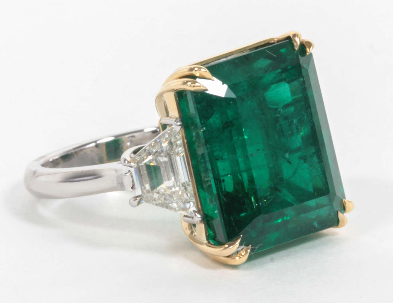 Important 20.89 carat emerald cut natural emerald set in a custom, handmade 18k and platinum mounting. 

1.51 carats of side diamonds.