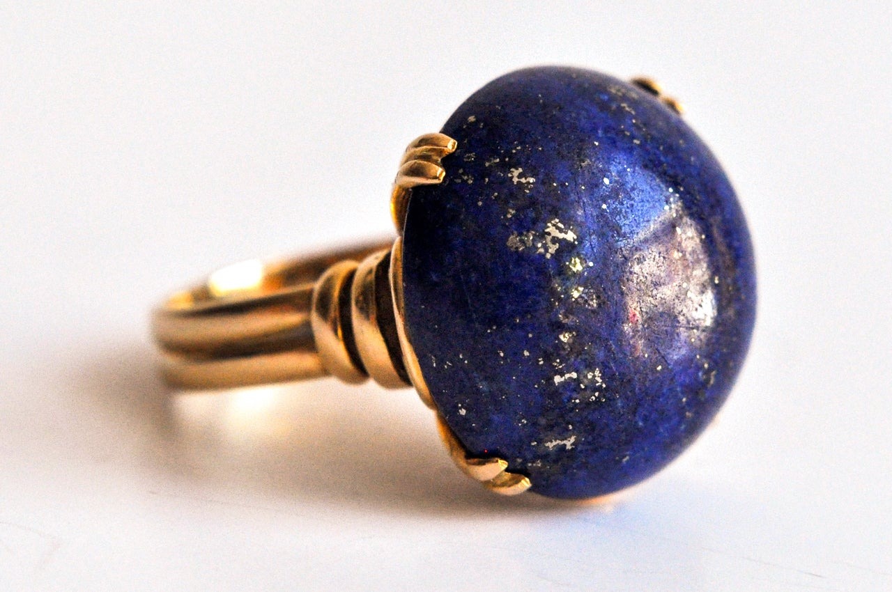 Brilliant, large blue cabochon lapis lazuli stone set in a modern, sculptural 18K gold setting. It's easy to understand why lapis was considered to be the 