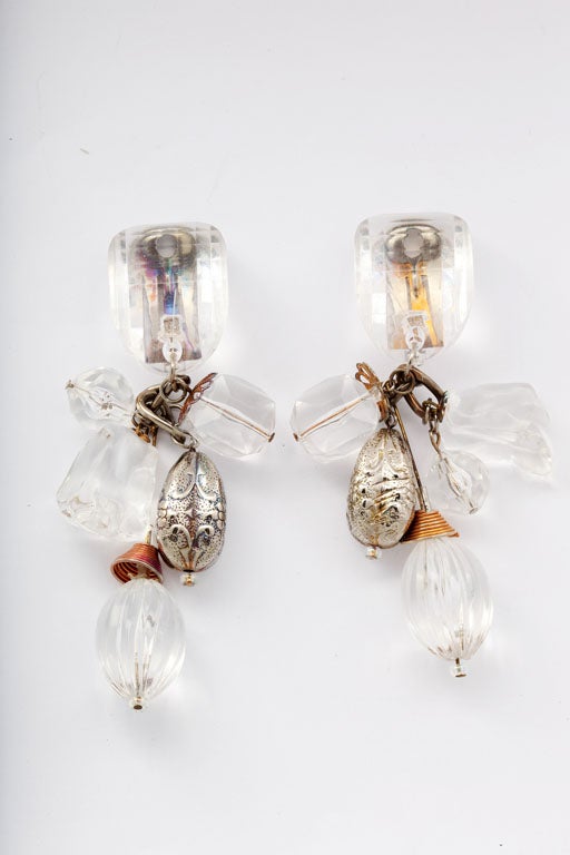 Lucite earrings with multiple dangling elements.