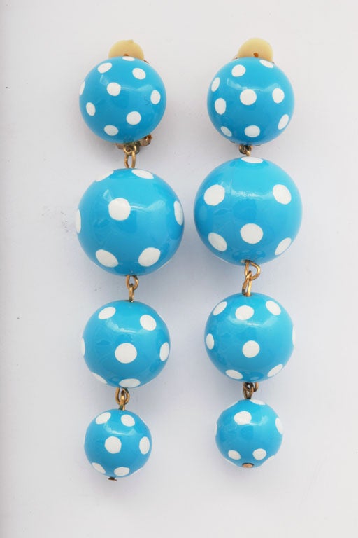 Four dangling turquoise polka dot ball earrings.