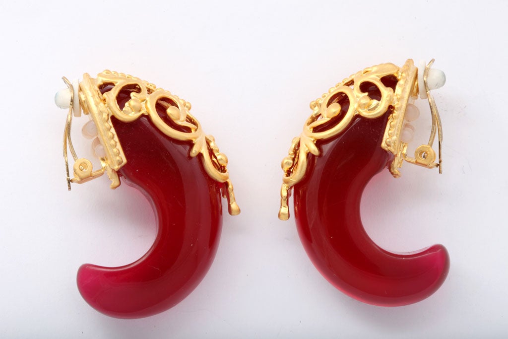 Hot pink/red lucite half hoop earrings adorned with goldtone filigree.