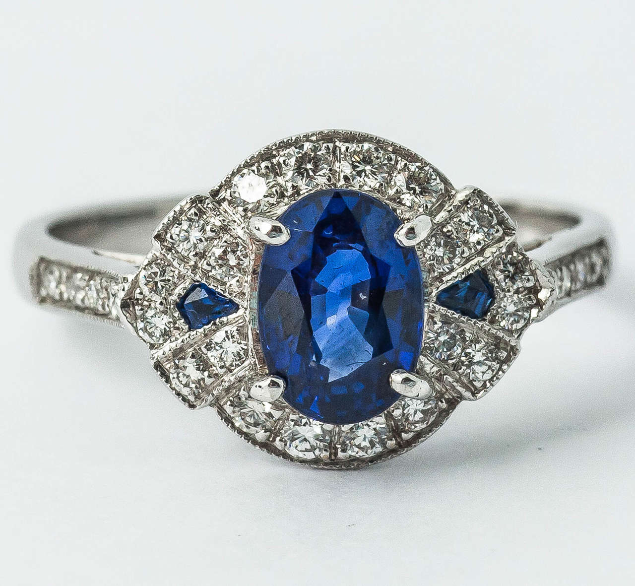 18k gold mounted sapphire and brilliant cut diamond ring with two sapphires in shoulder