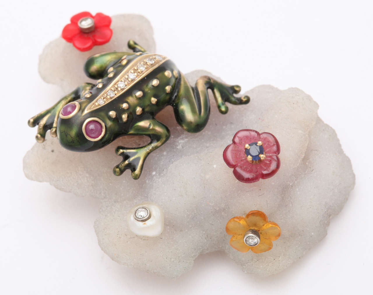 Enameled & bejeweled 14kt Yellow Gold Frog perching on a free form geode & mounted as a brooch.  Signed, copyrighted, & marked 14kt & New York.  The Frog is floating  & surrounded by tiny flowers, set with pearls & Diamonds.  Completely unique &