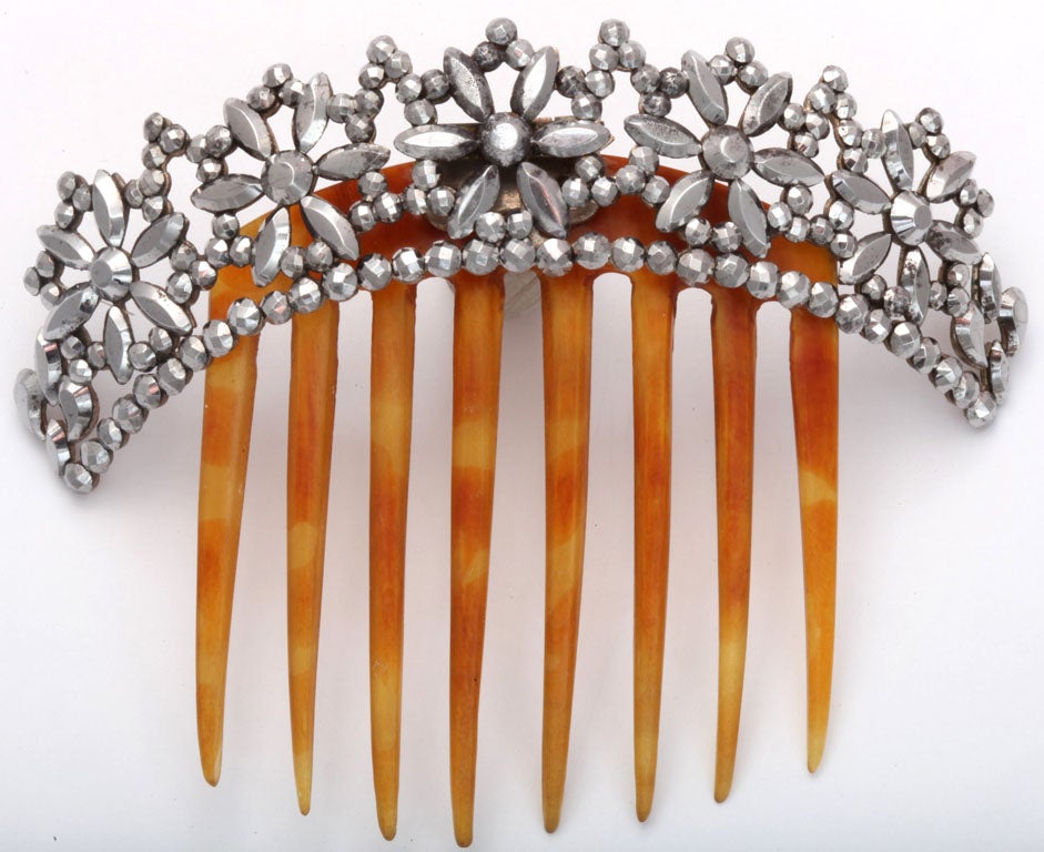 An original 19th century cut steel hair comb with all the sparkle of the day it was made. The ornament was cut, faceted and polished by hand around 1830. There are all kinds of reasons to put on some sparkle. We can partake in many activities we