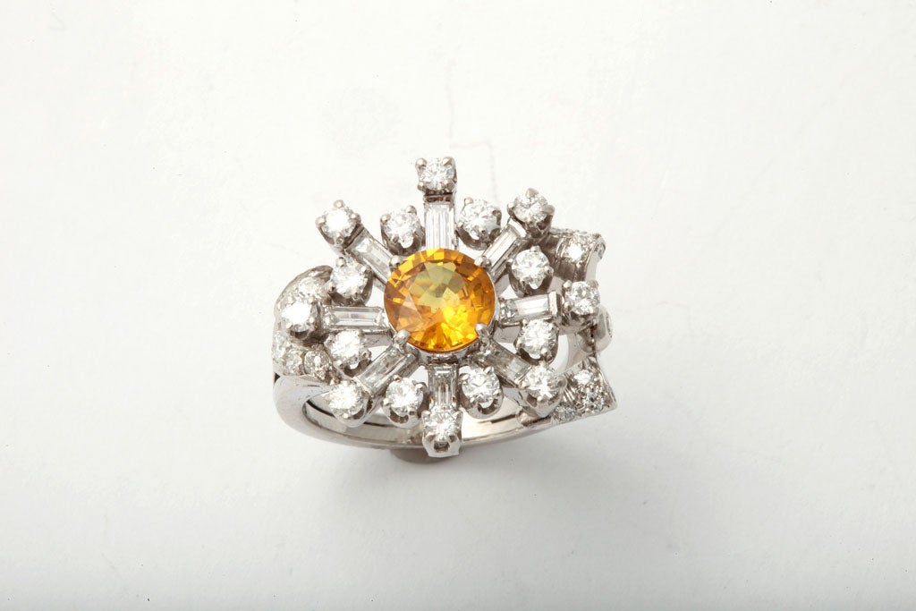 Stunning Platinum & Diamond Assymetric Ring center set with intense faceted Yellow Sapphire - approcimately 1.75cts, and set with radiating full cut Diamond brilliants & baguettes.  Stunning - whether worn as a pinky ring or on a ring finger.