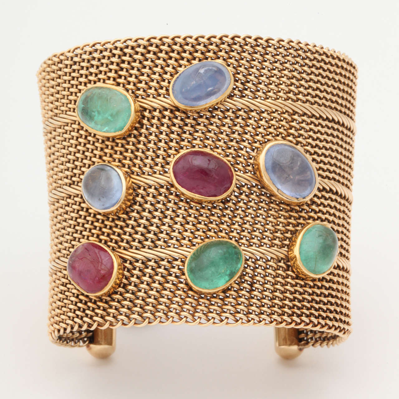 14 KT yellow Gold Heavy Large Open Cuff Mesh Bracelet Consisting of 8 Large Colored Stone Cabochon: 2 Rubies Weighing Approximately 10 Carats, 3 Cabochon Sapphires Weighing Approximately 15 Carats

American Made Circa 1950s