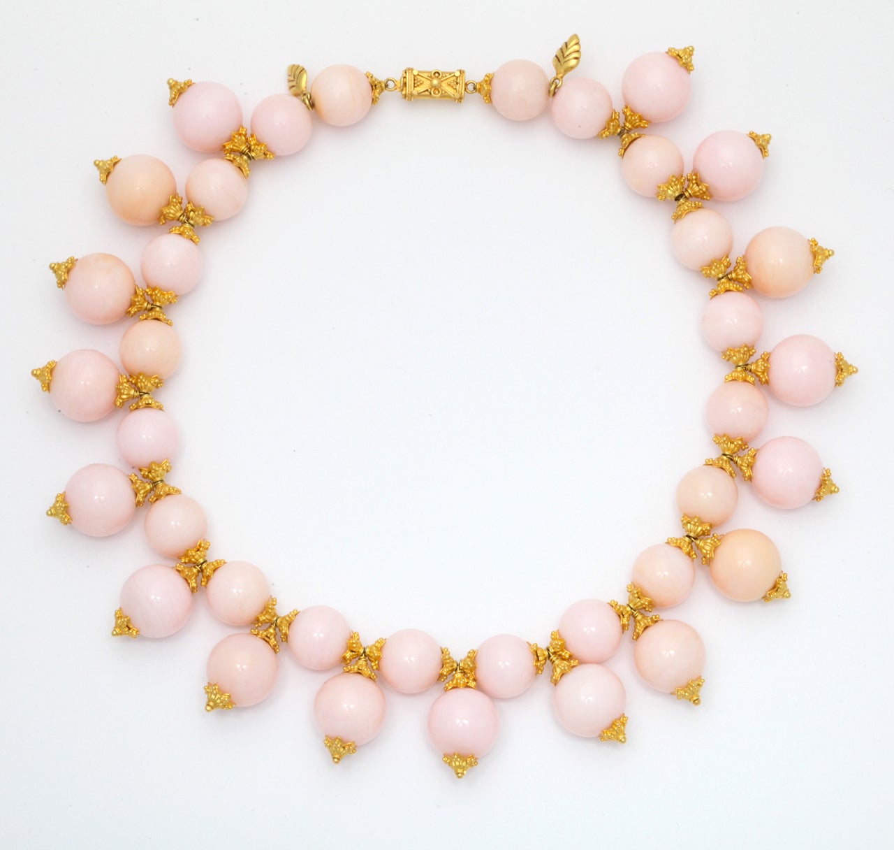 A necklace composed of peruvian opal beads, 22kt yellow gold flower caps, 18kt yellow gold headpins and an 18kt yellow gold clasp. 
This can be made longer.
Length: 16 inches
Width: 1.25 inches