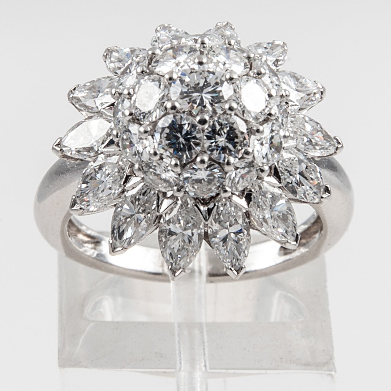 Domed cluster ring set with Diamonds in Platinum. Inscribed S.