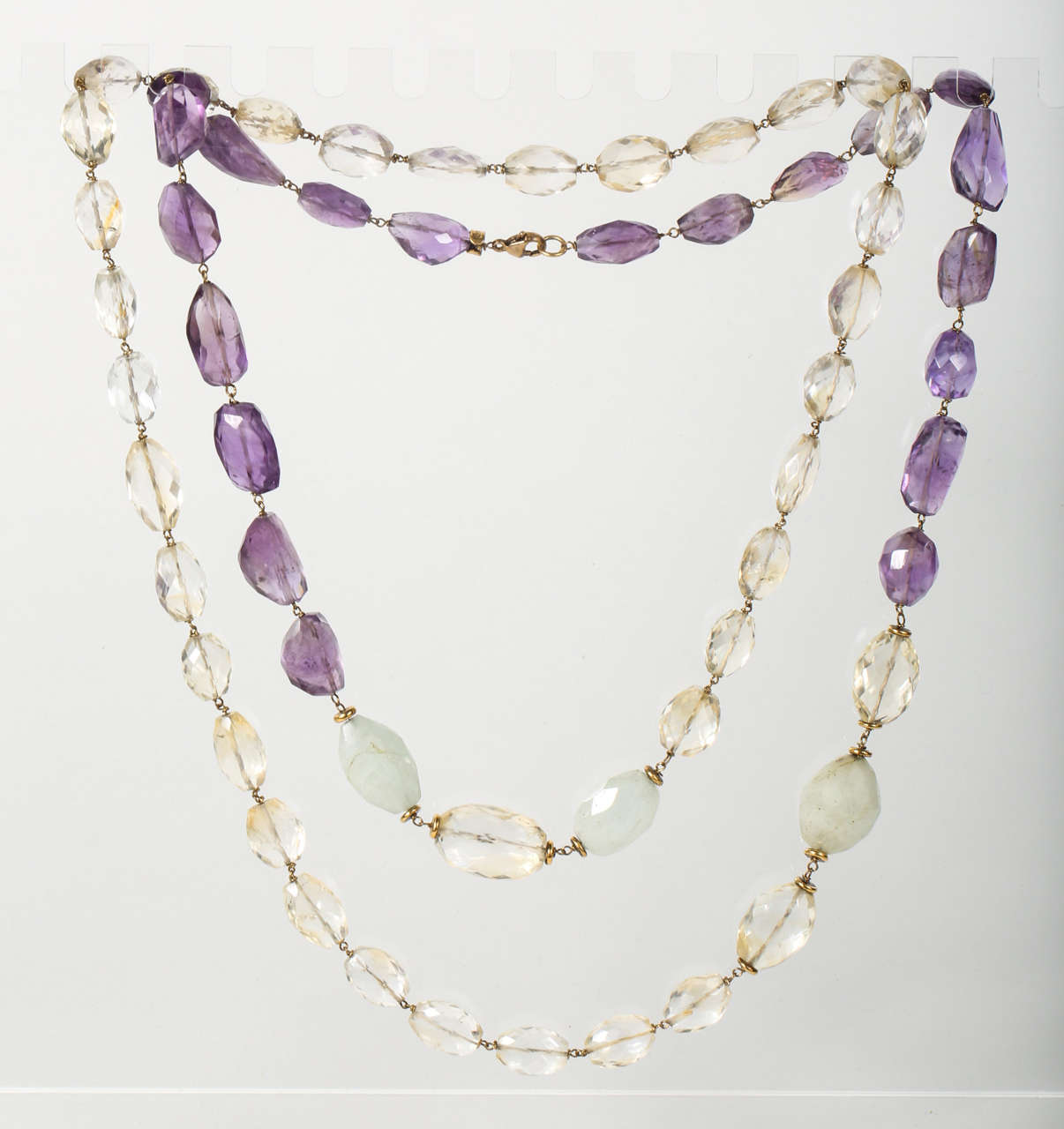 A stunning strand of faceted amethyst, citrine and white quartz beads by Iradj Moini that can be worn long or doubled up, as shown. The Iradj Moini nameplate is wrapped around the top of the amethyst at the necklace clasp (see Image 7).