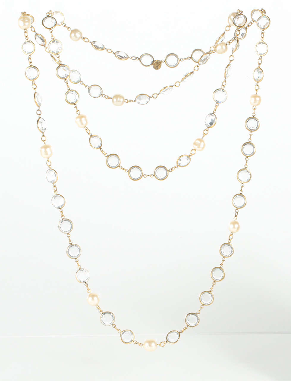 A sparkling faceted crystal and irregular glass pearl sautoir by Chanel. Features the 