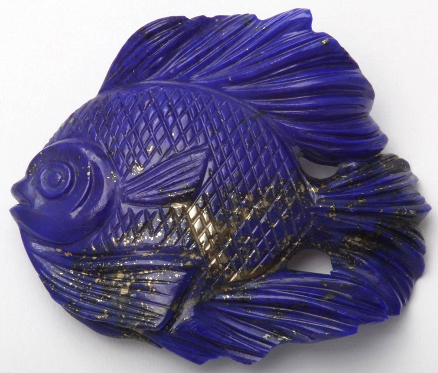 A hand carved lapis lazuli fish weighing approximately 25cts