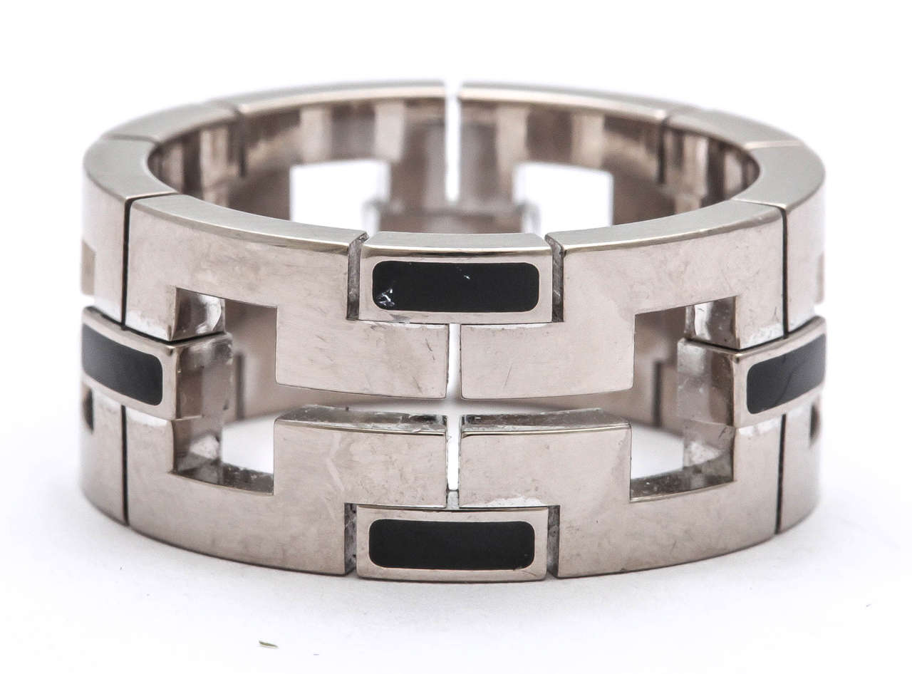 Bold Cartier 18Kt White Gold and Black Enamel Band.  One size - 10.1/4.  Can be slightly adjusted.  Very strong design. Signed Cartier & marked 750.  French touch mark.  All inscribed on outer edge of the Band.