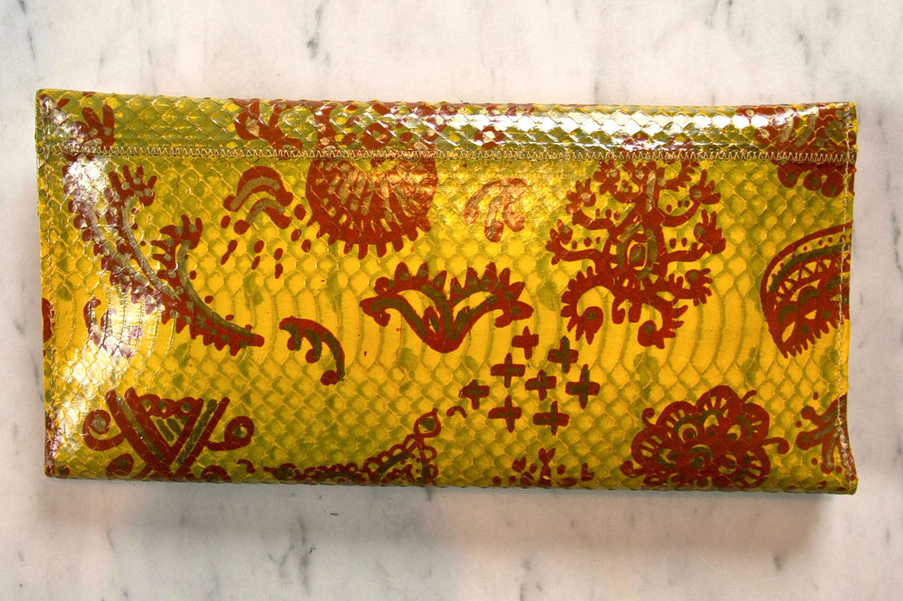 conversational carlos falchi clutch featuring unique hand painted accents. optional lavish link chain for shoulder use. we have not seen another.