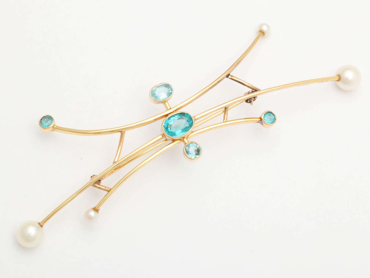Of curved linear design, in 18k gold accented with light blue Murano glass and cultured pearls.

20th century, signed.

4 in. (10.2 cm.) long.

Maurice Brault (1930-2018) was a Montreal based jeweler, enameler and silversmith. Brault studied in