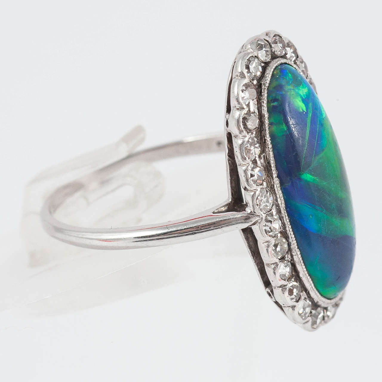 Black Opal ring of Lightning Ridge origin surrounded by fine Diamonds set in Platinum.

Finger size N 1/4