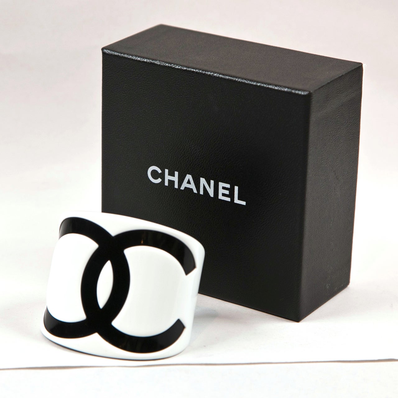 Chanel cuff resin blak and white with box in mint condition.  Unusual for Chanel, marked in center