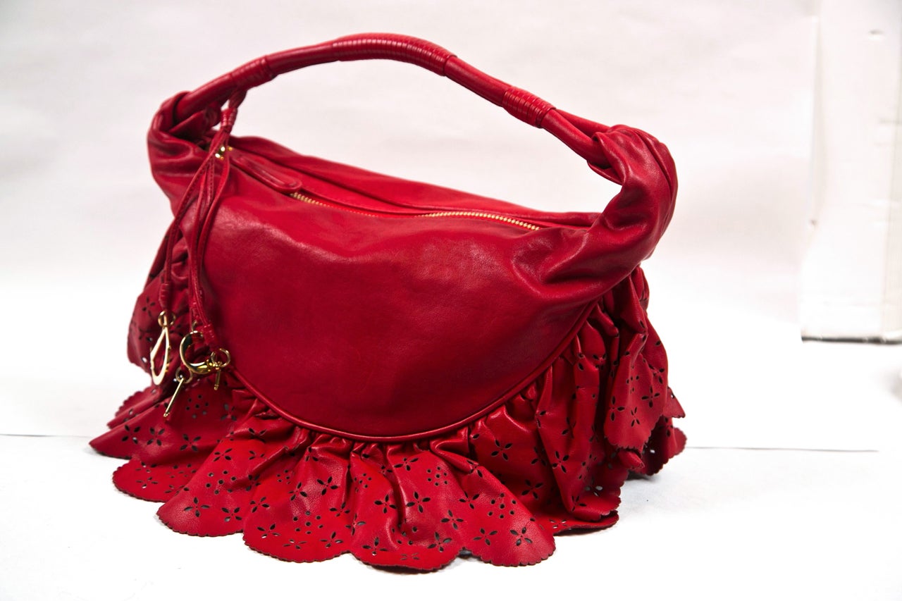 Red Christian Dior of Paris reticulated ruffled handbag with gold hardware and original dust bag.