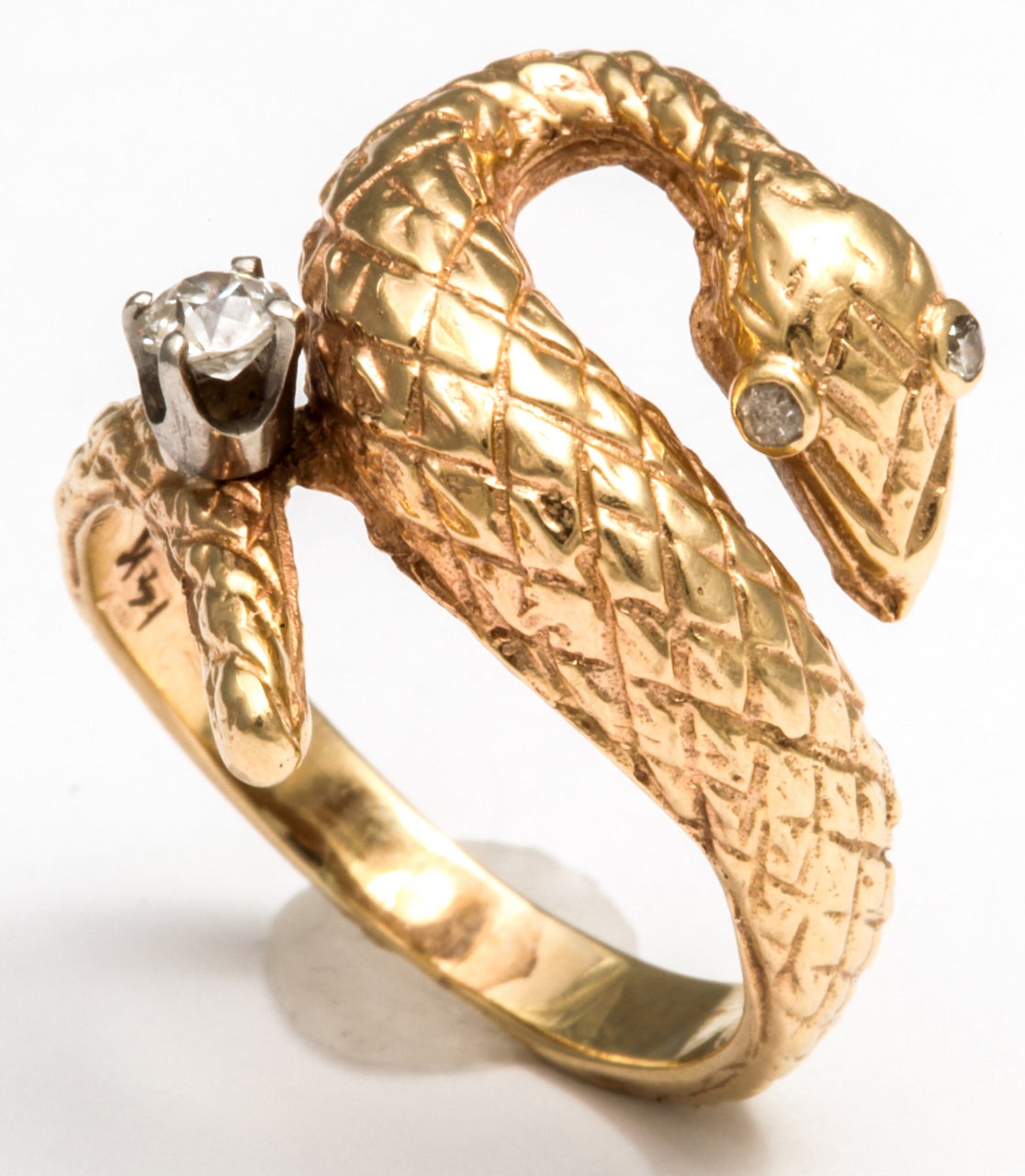 20th century 18k gold snake ring, well articulated with .25ct European diamond, and small bezel sest diamonds in the eyes.