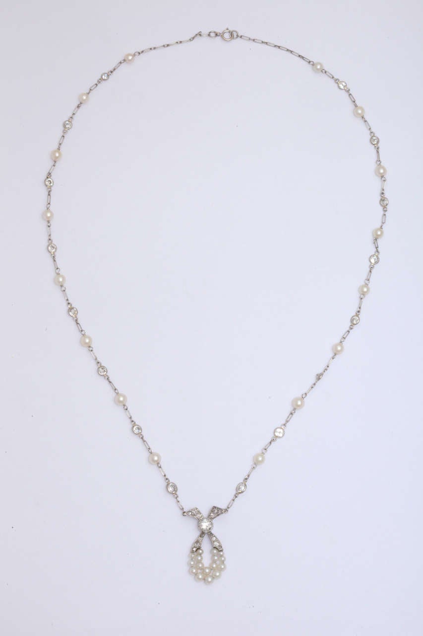 Edwardian Handmade Platinum necklace consisting of 16 old mine cut diamonds with alternating 16 cultured pearls on chain connected to Pearl and Diamond Pendant Total weight of diamond 2 carats American made circa 1910
