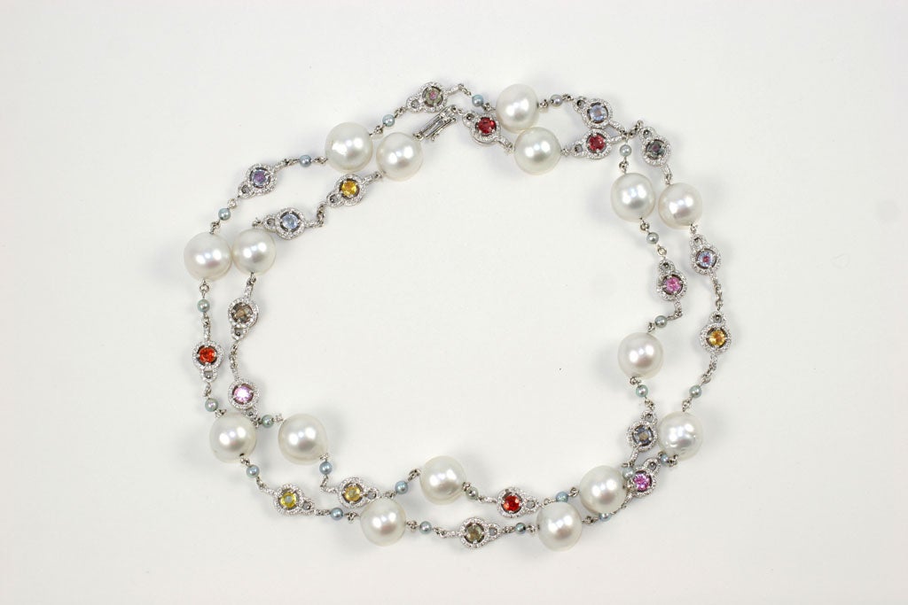 18 k South sea pearl and colored stone necklace with micro pave diamonds surrounding each stone.5.26 Diamond weight and 13.60 colored sapphires.