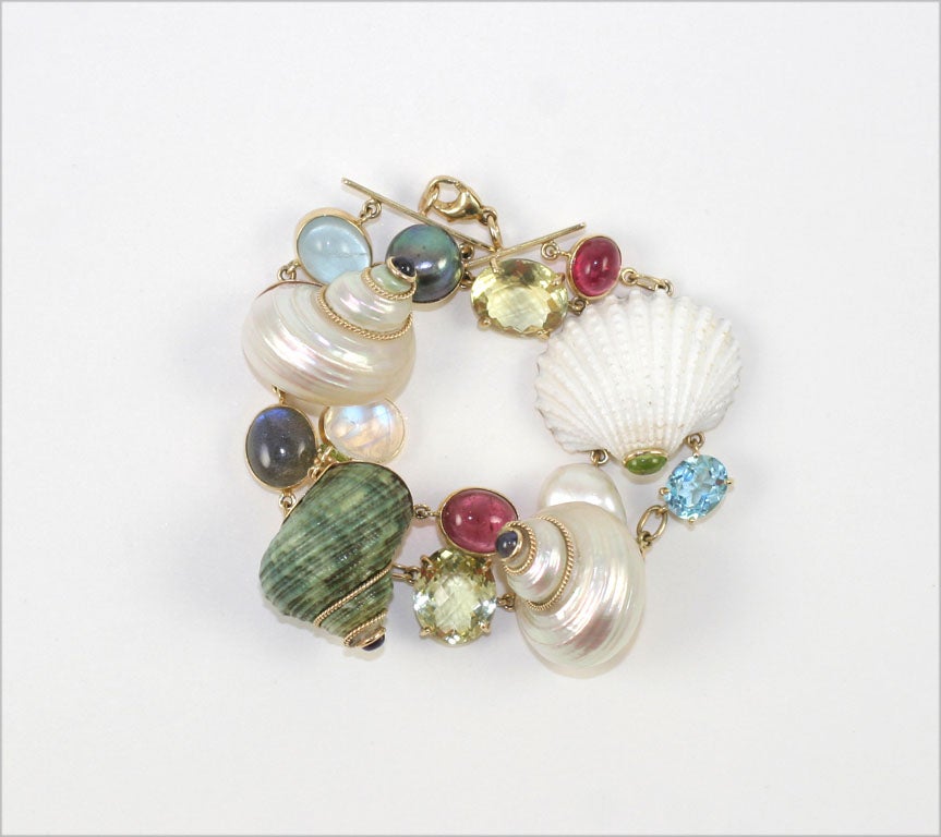 Gems of Sea and Land bracelet, shells and semi precious are gold wrapped and linked to form harmony and a delight of subtle colors.Sea Shells, Tourmalines, and Aquamarine set in 18K Gold.