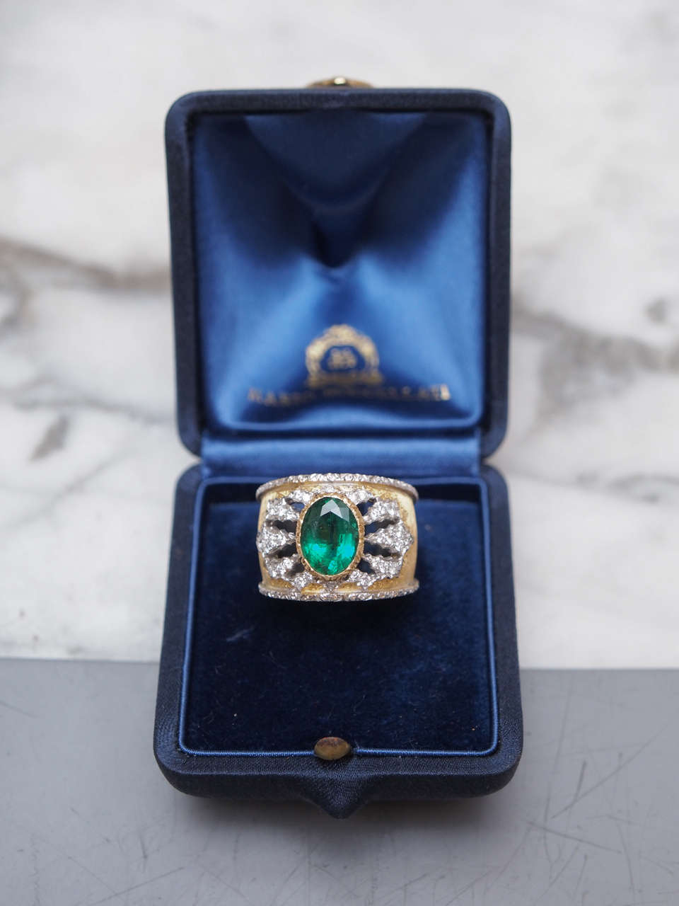 Exceptional Signed Mario Buccellati  Emerald and Diamond Ring. Crafted in 18kt Gold Containing a 1.55 Carat Oval Emerald and Pave Diamonds