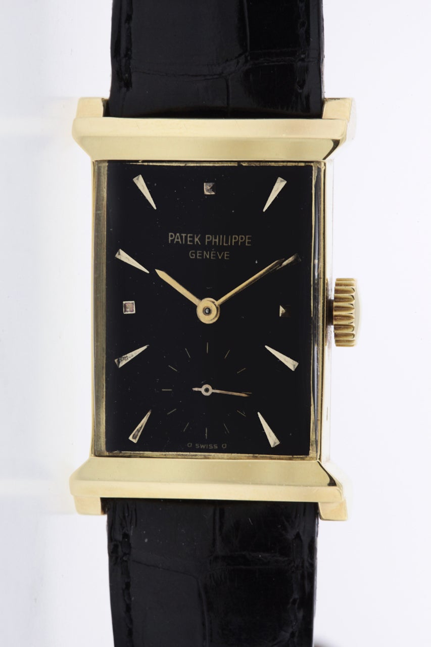 18K yellow gold extremely rare Patek Philippe rectangular wristwatch, Ref. 2404, circa 1952, with black dial with applied gold 