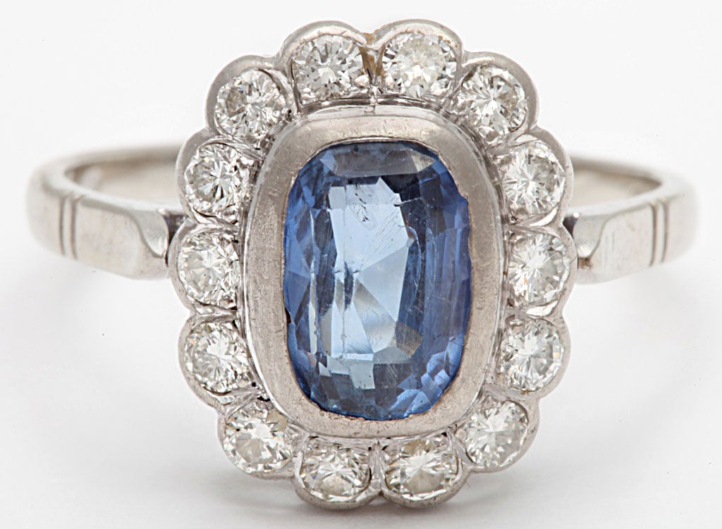 14k white gold mount containing center cuhshion Ceylon Sapphire approximate weight 2.00 carats 14 found diamonds 0.60 carats